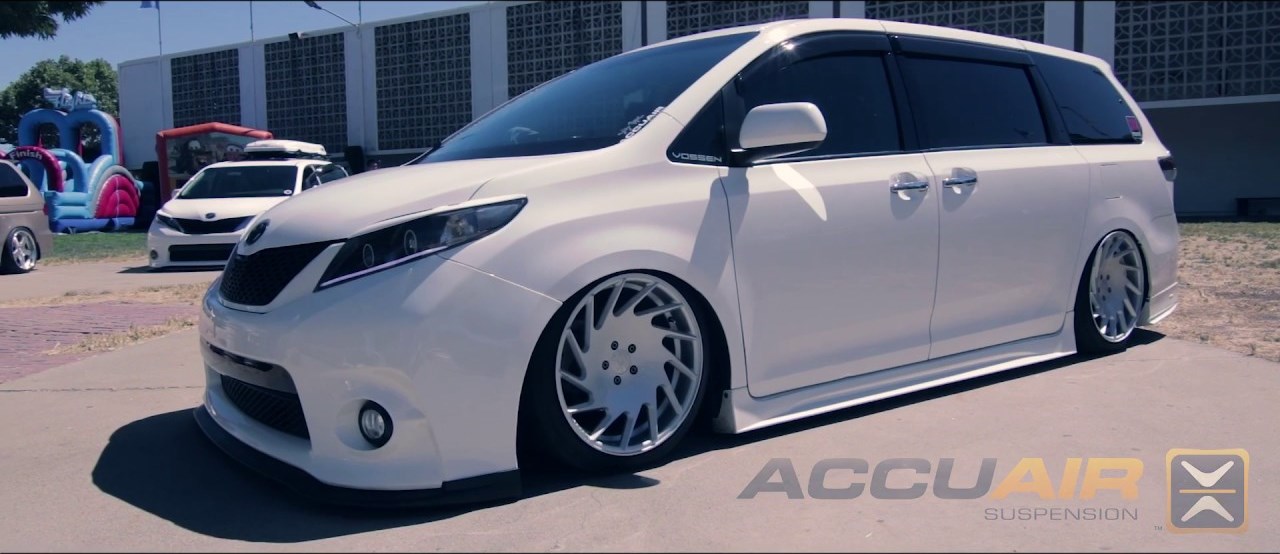 White lowered Toyota Sienna on air suspension, side profile