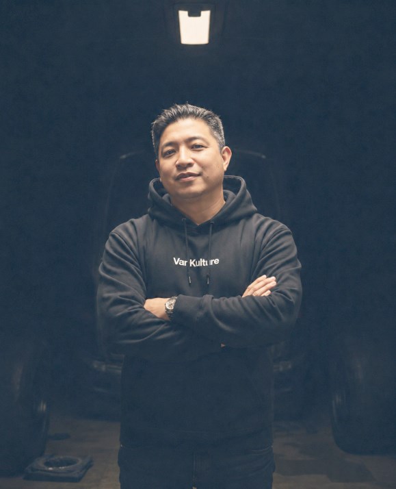 The founder of VanKulture standing in front of a van inside the workshop